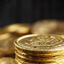 Small stack of gold coins with a shimmering effect, representing a small virtual currency pack.